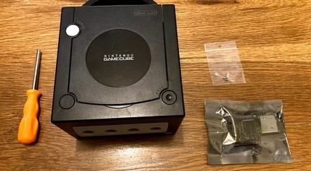 Clockwise, from top left: 1) What you'll need for the mod. 2) Remove the lid and you'll find that there are lots of screws to remove in order to detach the GameCube's optical drive assembly. 3) Under the drive, you'll need to remove more screws to detach the actual optical drive – the GC Loader connects to the metal plate, which you'll need to retain. 4) The GC Loader slots into the connection which was used to link the drive to the mainboard.