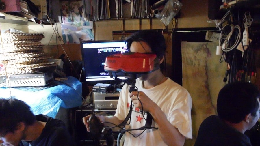 "The Area 51 retro bar in Tokyo; the proprietor tests his Virtual Boy in the middle of the bar, as one does..."