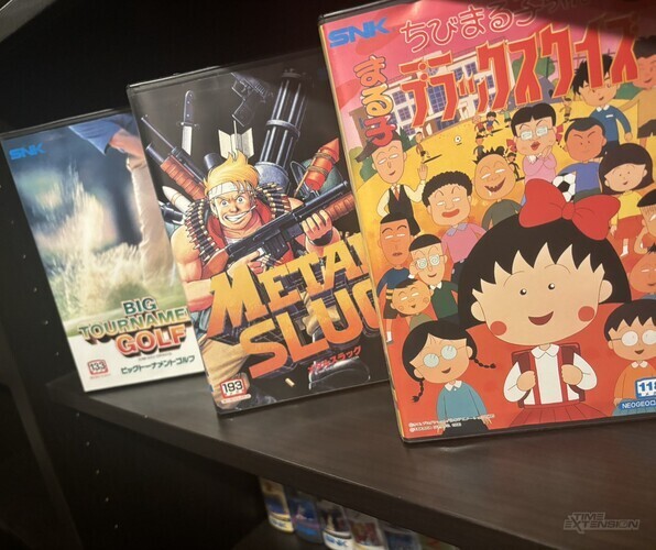 Chibi Maruko-Chan Quiz, Metal Slug, and Big Tournament Golf (left). (Top right) A South Korean Vic-A Neo Geo console. (Bottom right) A copy of Magician Lord from back when the Neo Geo AES was a rental machine