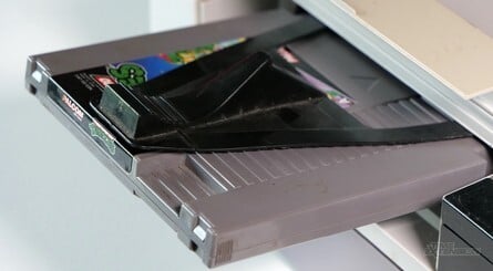 The original NES Game Genie sat between to the game cartridge and the console